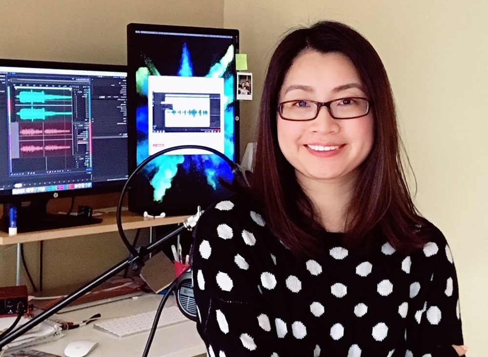 Ying Wang Game student sitting in front of her computer screens